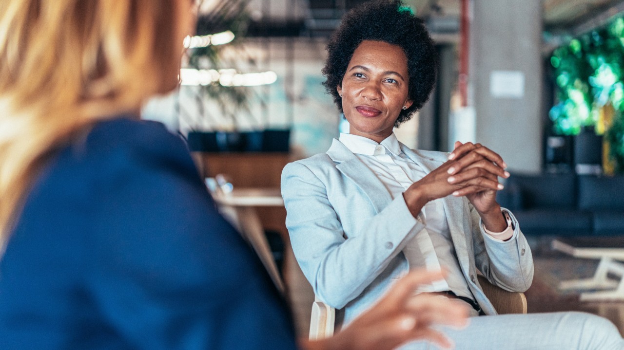 Two women in conversation. One listening without speaking.